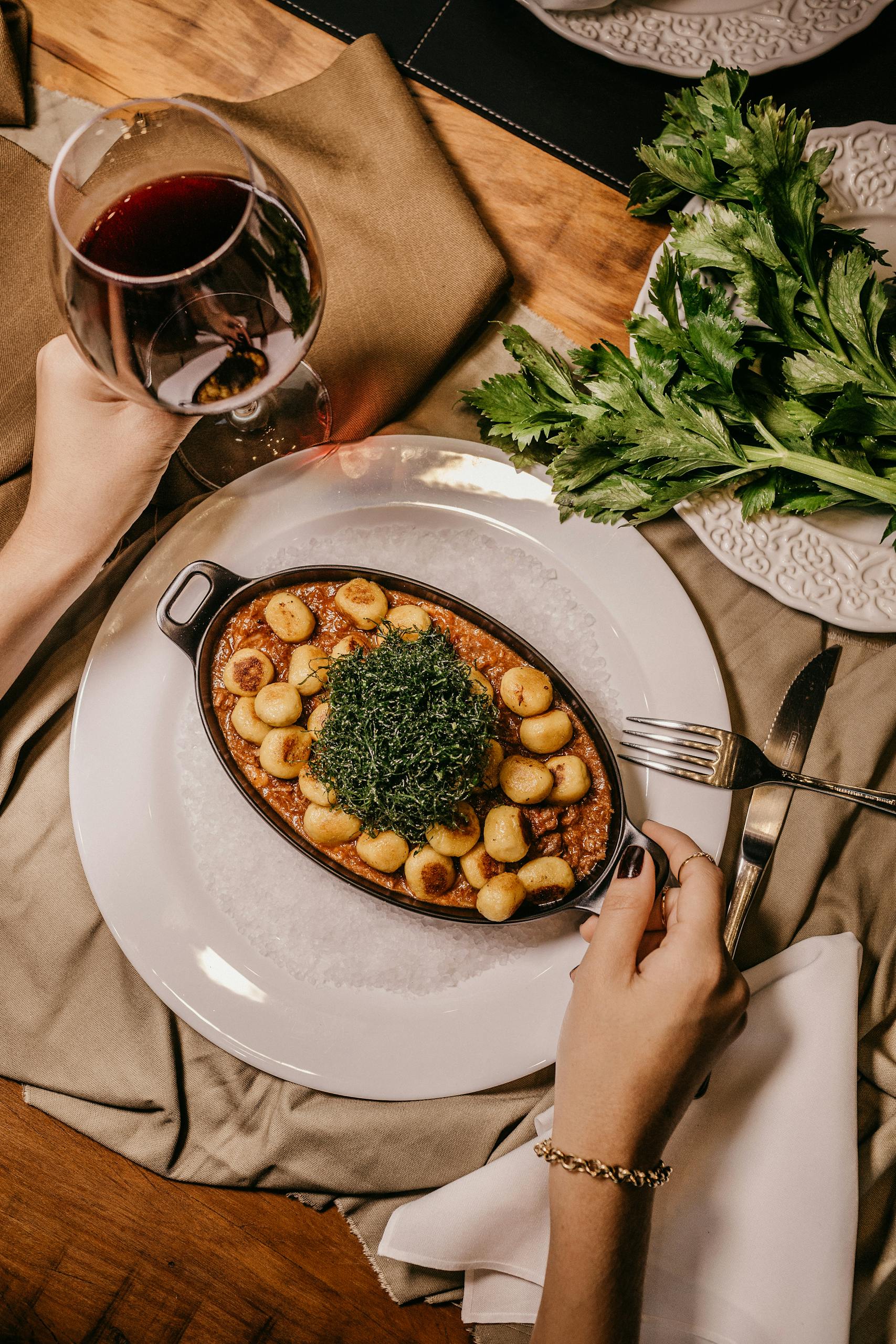 A gourmet meal served with red wine in an elegant dining setting. Perfect for fine dining concepts.