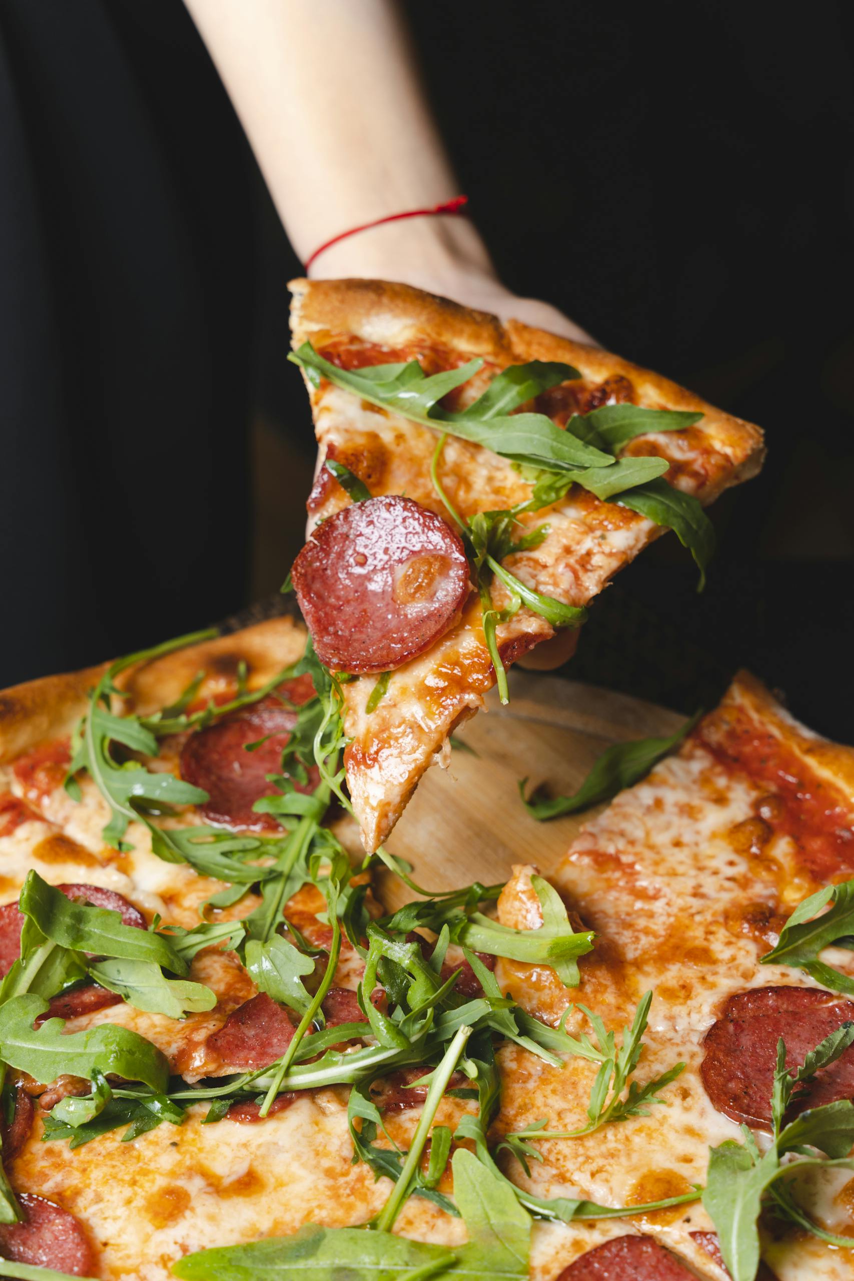 Delicious pepperoni pizza topped with fresh arugula being served in Baku, Azerbaijan.